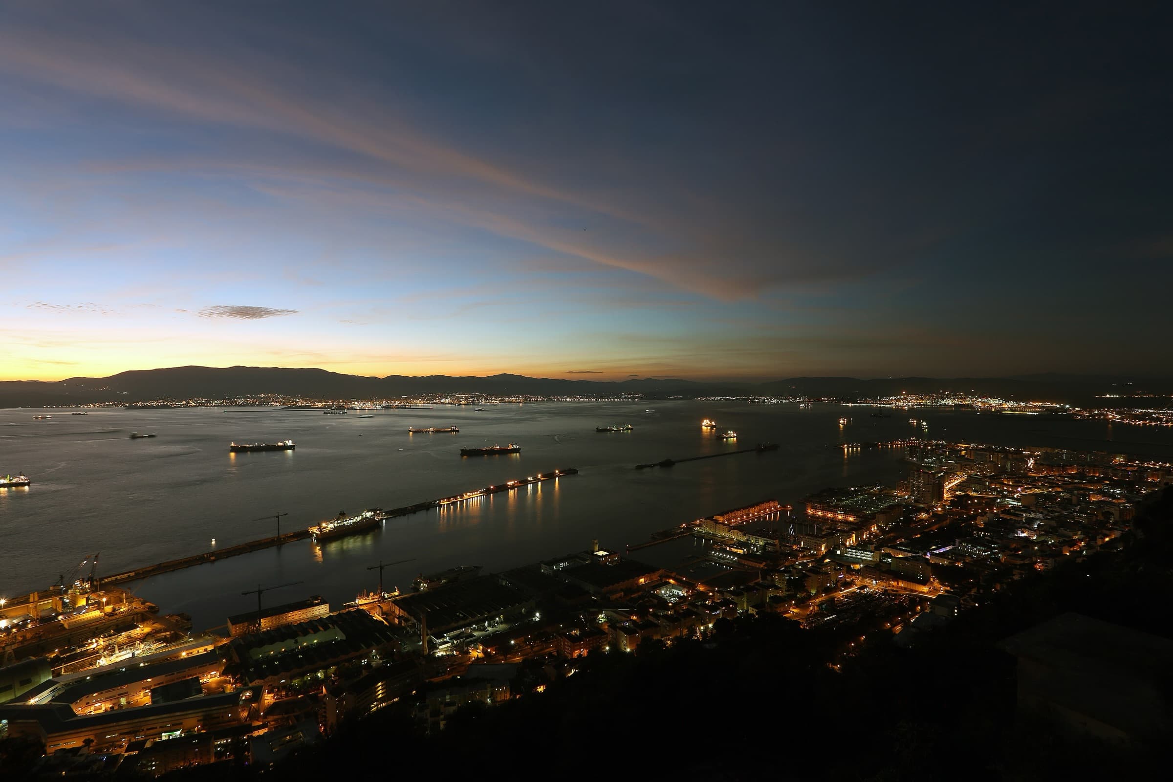 The Bay of Gibraltar at dusk, with the lights of the port below