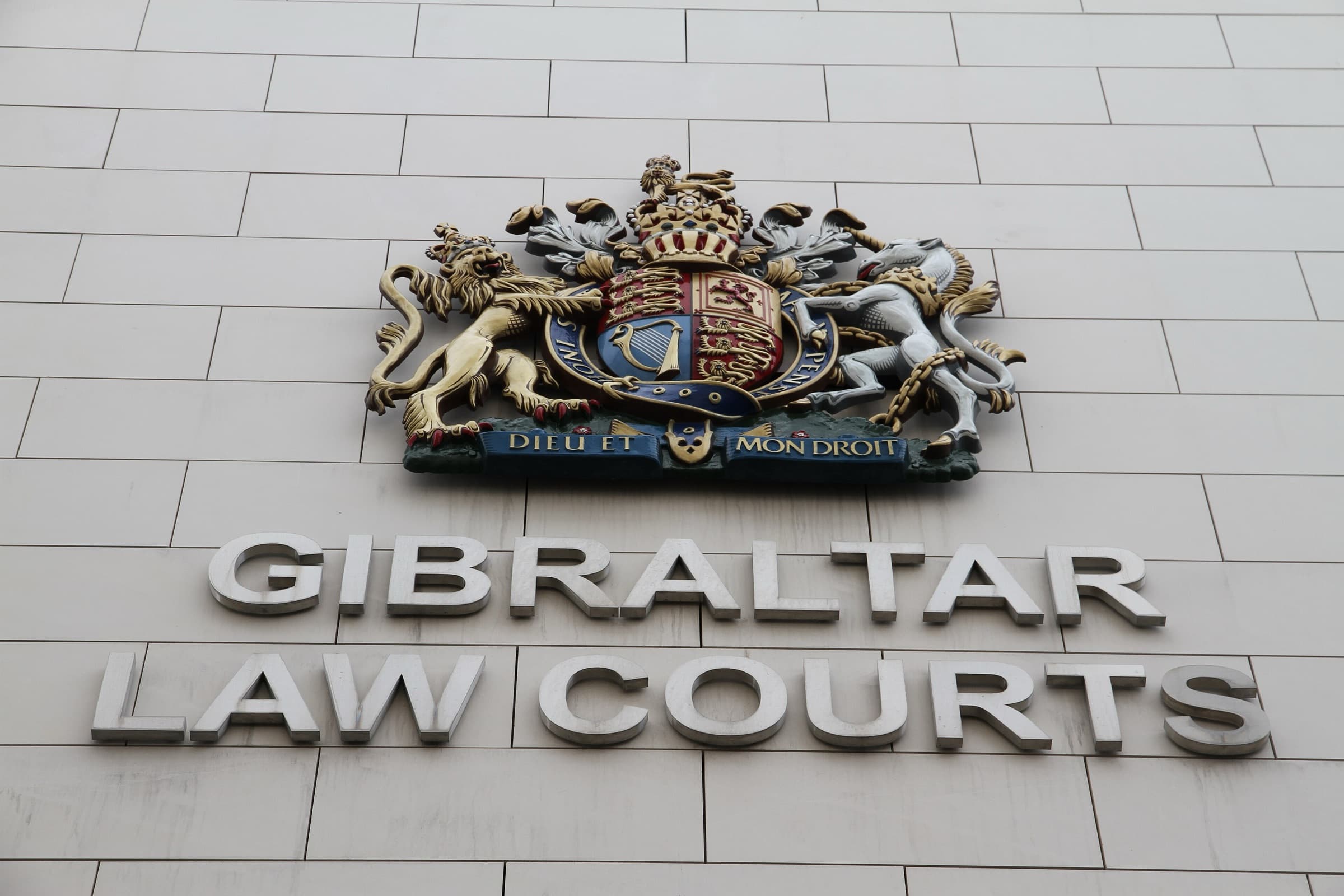 The sign and coat of arms on the front of the Gibraltar Law Courts