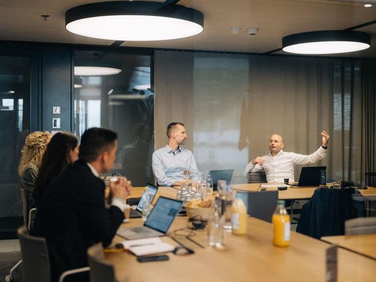 Colleagues in a meeting around a boardroom table